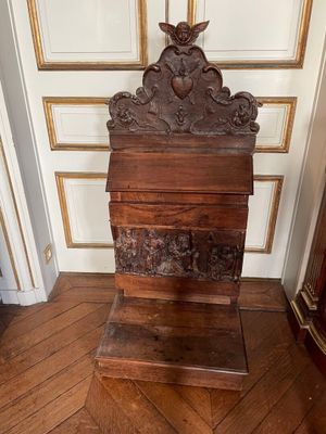 a wooden box with a bird on top of it on a wooden floor