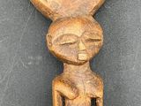 a close up of a wooden object on a black surface