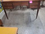 un bureau et une chaise dans une pièce où il y a beaucoup de meubles