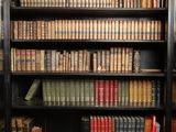 a bookcase with many books on top of it