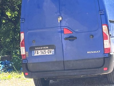 a blue van that is parked on the side of the road
