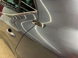 an image of a car door handle with a hole in it