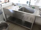 a sink and a mixer in a kitchen with a window