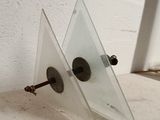 a small mirror on a shelf next to a window