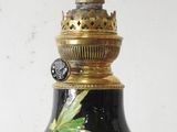 a black and gold vase with flowers painted on it