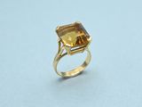 a gold ring with a citrine stone in the center