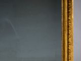 a mirror that is sitting on a table in front of a wall