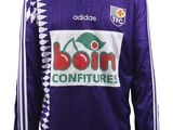 a close up of a soccer jersey with a logo on it
