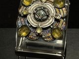 a glass box with a ring on it on a table