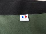 the back of a green shirt with a heart patch on it