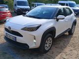 a white toyota c - hr parked in a parking lot