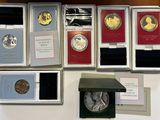 many different types of coins on display on a table