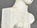 two white sculptures of a woman and a man on a gray surface