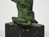 an image of a statue of a monkey sitting on top of a wooden block