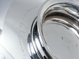 a close up of a silver plate with a ring on it