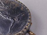 a silver coin sitting on top of a white surface
