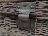 a close up of a wicker basket with a metal latch