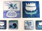 four pieces of artwork on the wall of a room