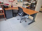 a desk with a chair and a computer on it in a room