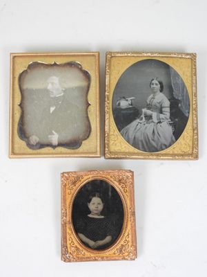 three framed photographs of a woman in a dress and a man in a dress