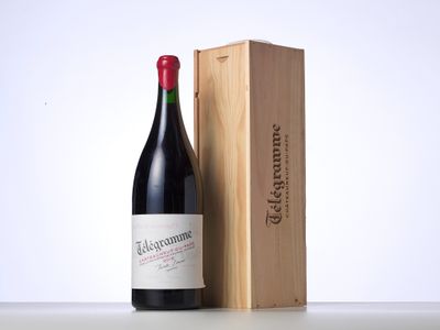 a bottle of wine sitting next to a wooden box