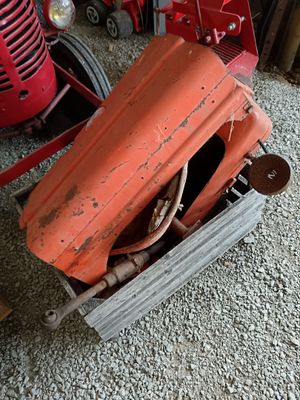 a red tractor and a red tractor in a garage