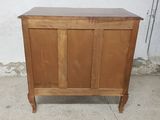 a wooden cabinet with a door on top of it