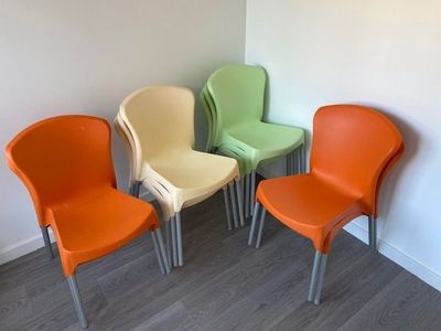 four chairs that are sitting in a row in a room