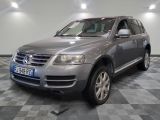 a picture of a silver volkswagen suv parked in a garage