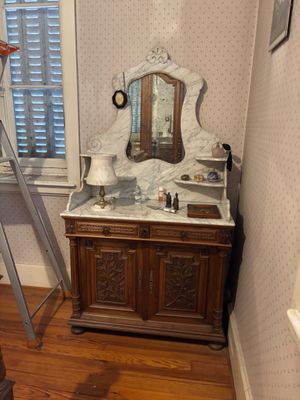 a ladder leaning against a wall next to a bathroom sink