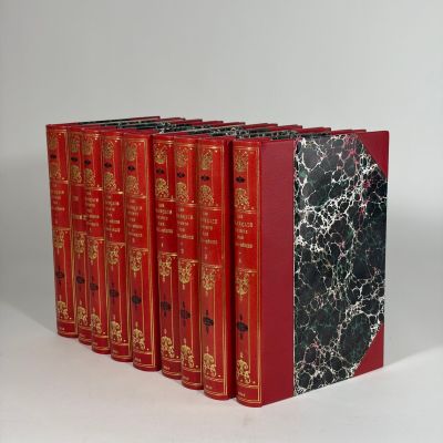 six red books lined up on top of each other on a white surface