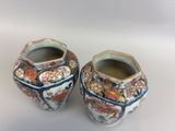 two vases that are sitting on a white surface