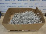 a cardboard box filled with lots of silver scissors