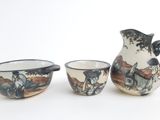 three bowls and a pitcher sitting next to each other