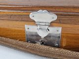a close up of a wooden suitcase with a metal latch
