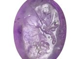 a close up of a purple soap ball on a white background