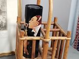 a wine bottle holder that has a picture of a man in a tuxedo