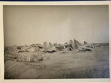 an old black and white photo of a desert area with tents and tents