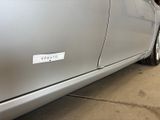 a sticker on the side of a car that is parked in a garage