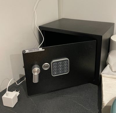 un coffre-fort noir posé sur un comptoir à côté de des toilettes
