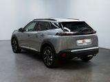 the rear end of a silver suv parked in a room