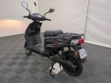 a scooter parked in a room with a checkered floor