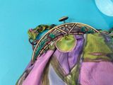 a purse with a purple and green design on it
