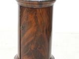 a small wooden table with a marble top on it