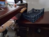 a desk with a computer monitor and a basket on top of it