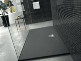 a black and white photo of a bathroom with a walk in shower