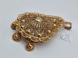 a close up of a gold broochle with a small turtle on it