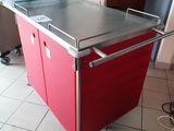 a red kitchen island with a metal top in a kitchen