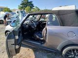 a car that is parked in a lot with its door open