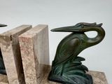two bookends that are sitting on a marble block